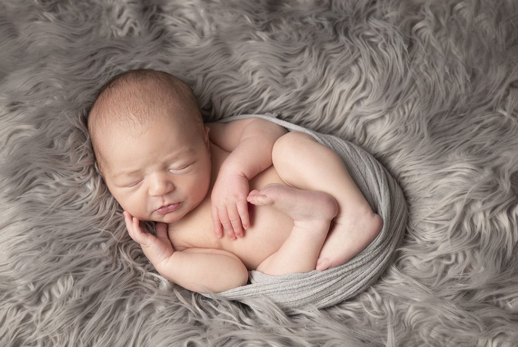 sleep baby posed in a wrap by newborn photographer Dumfries