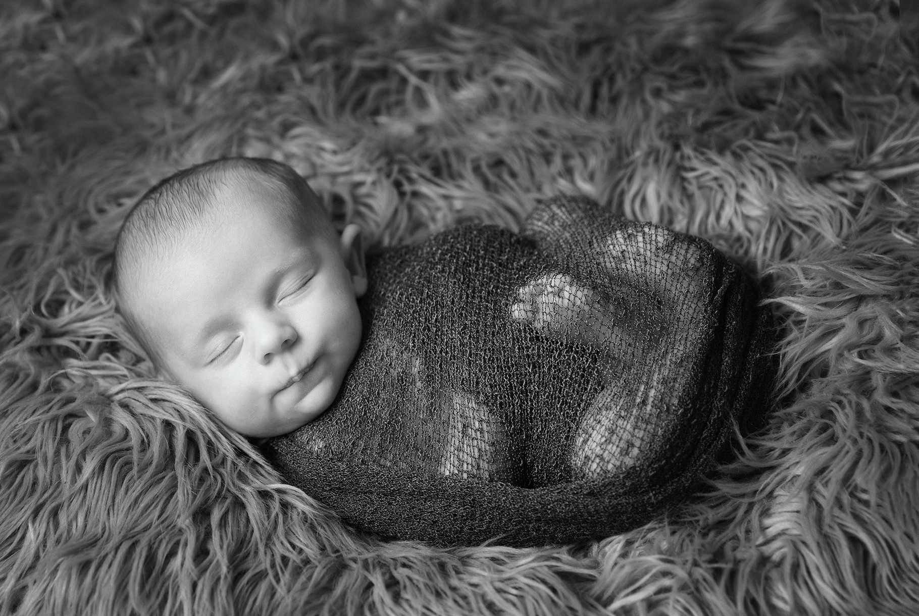 sleeping baby wrapped up by baby photographer Dumfries