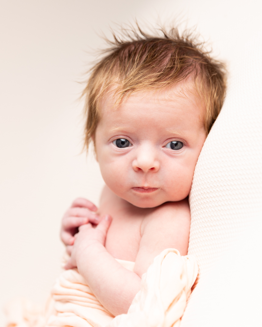 newborn baby awake with eyes on camera