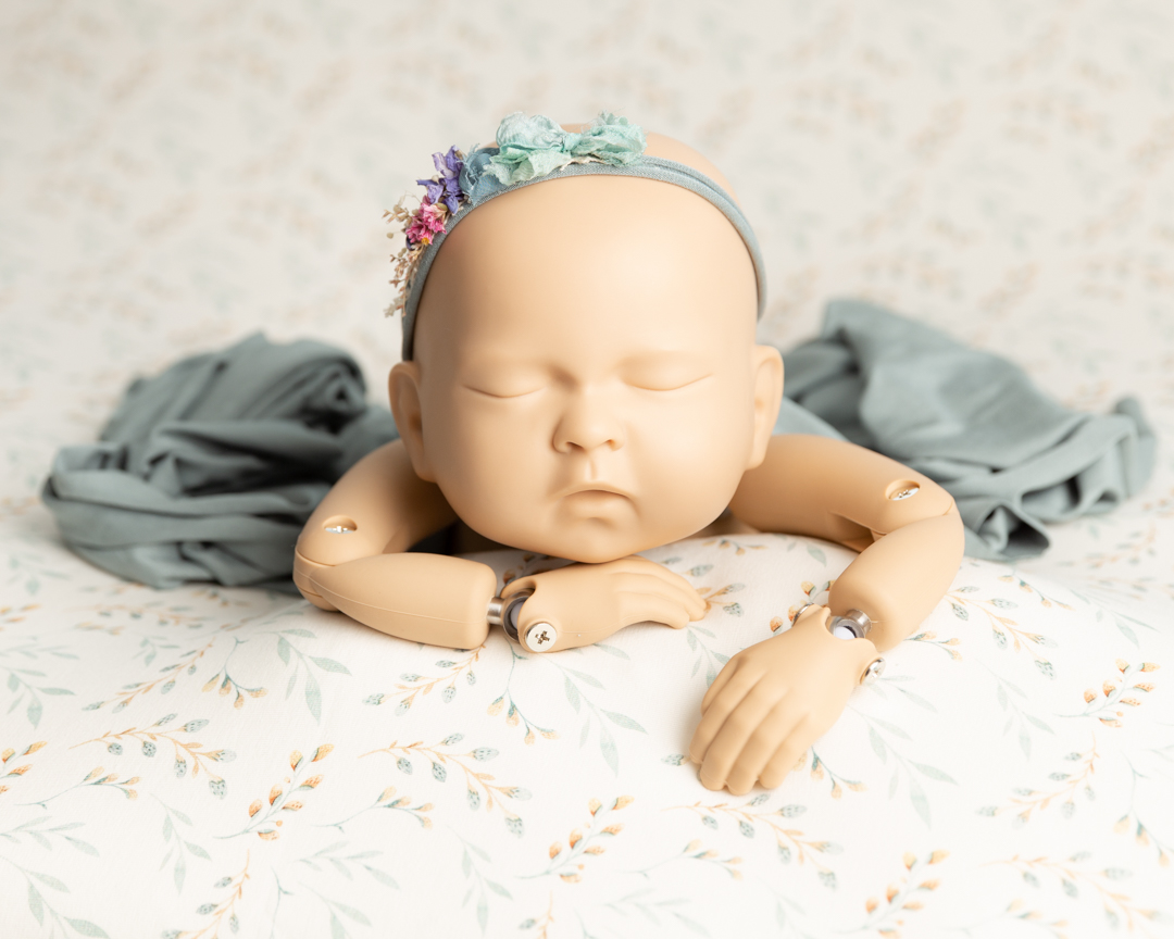 image of newborn baby girl doll during photography session