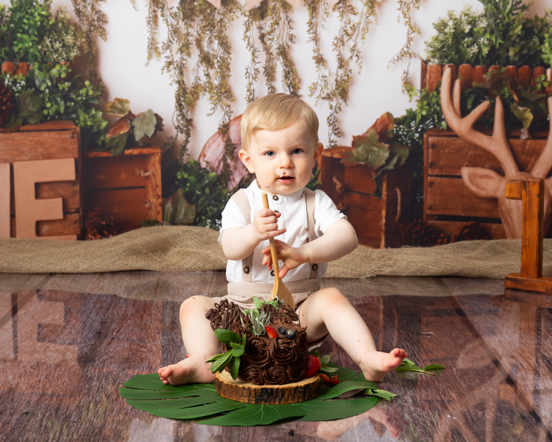 boy with chocolate cake and wooden spoon