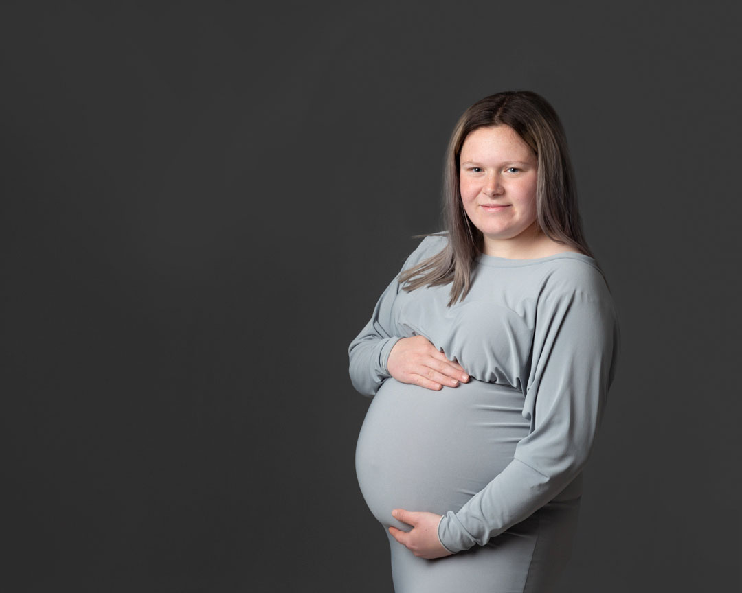 pregnant lady wearing grey dress by maternity photographer Dumfries